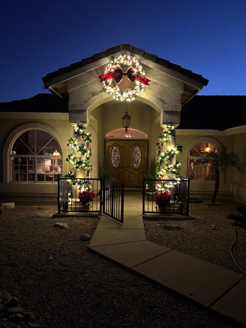 Lighted wreath and garland-wrapped entry columns at a Scottsdale home
